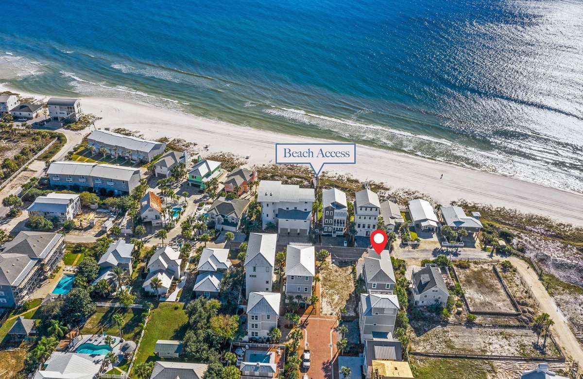 Aerial view of beachfront neighborhood showing direct beach access