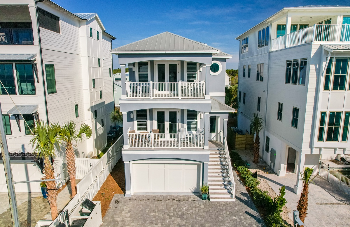 Three-story beach house exterior with balconies and coastal architecture