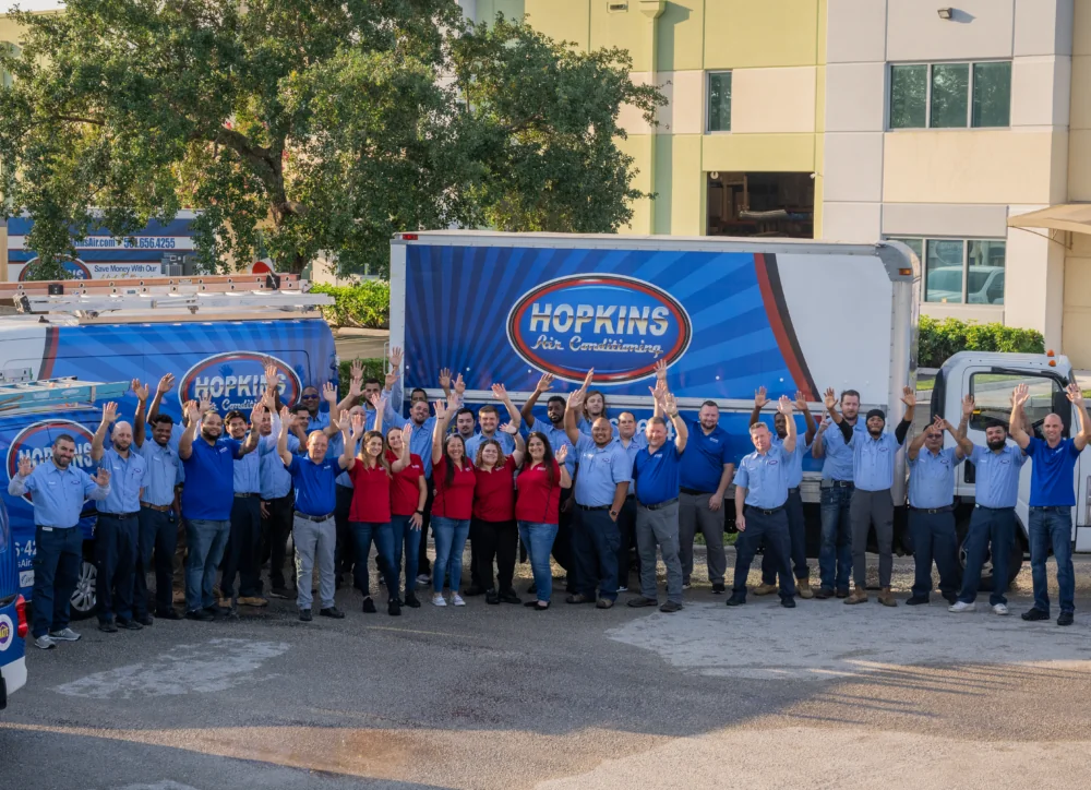 The Hopkins Air team standing in front of their trucks