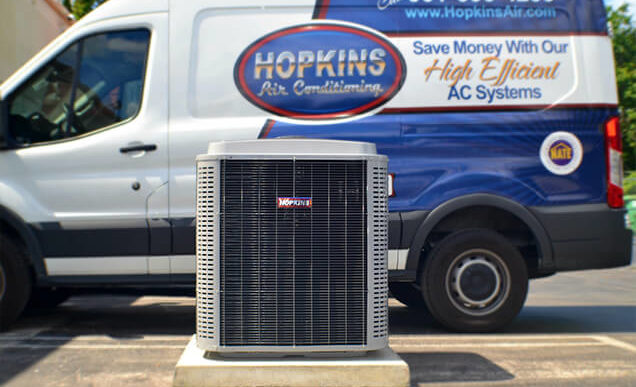 Hopkins Air Conditioning truck behind a new AC unit