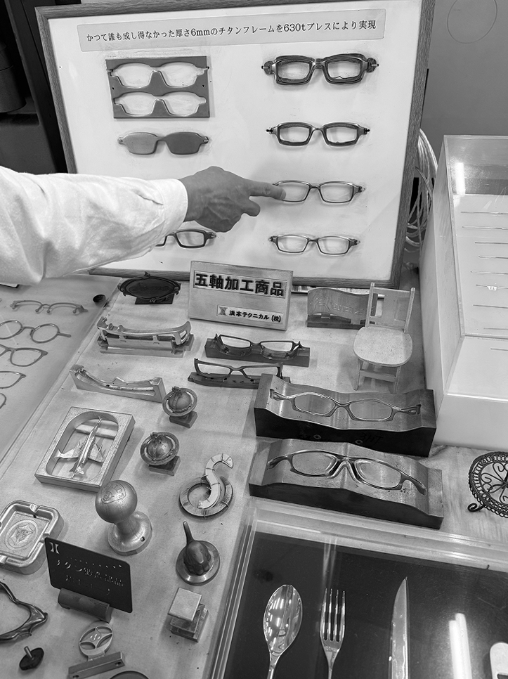 A collection of raw, milled DRK frame components on a wooden workbench, showcasing the solid, sculptural forms before they are hand-finished.