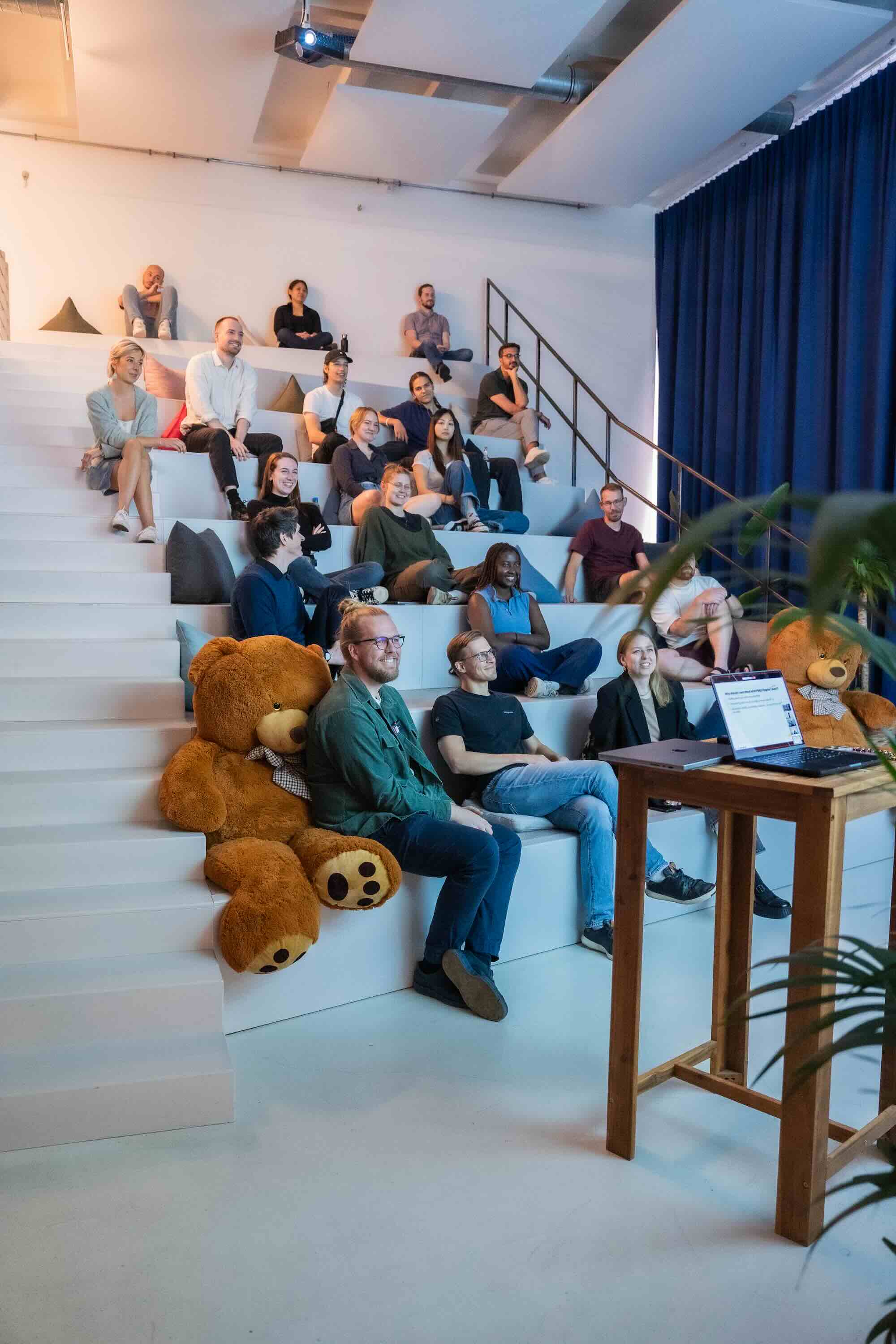 A crowd looking towards a speaker