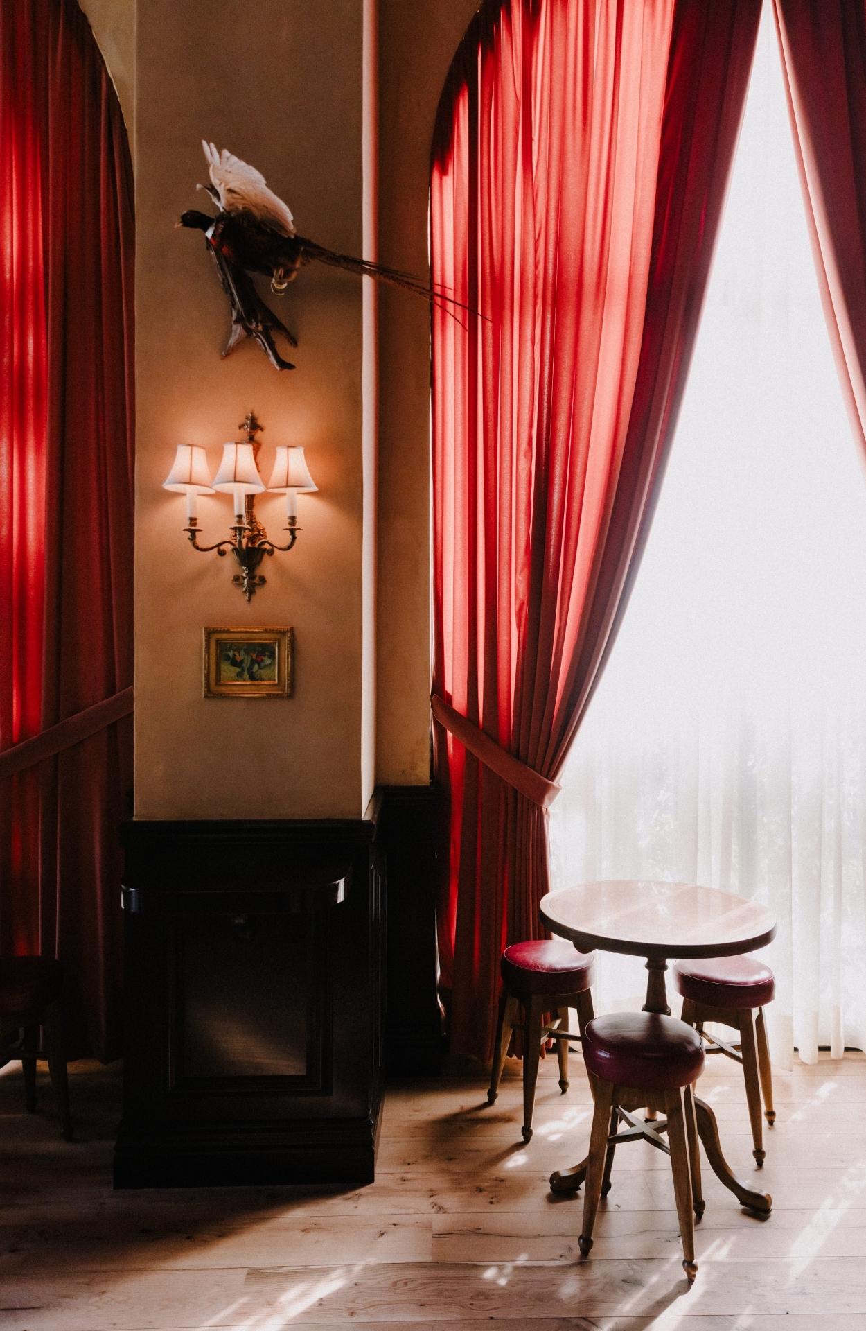 A vintage photograph of Western cowboys having a drink in a saloon-style bar