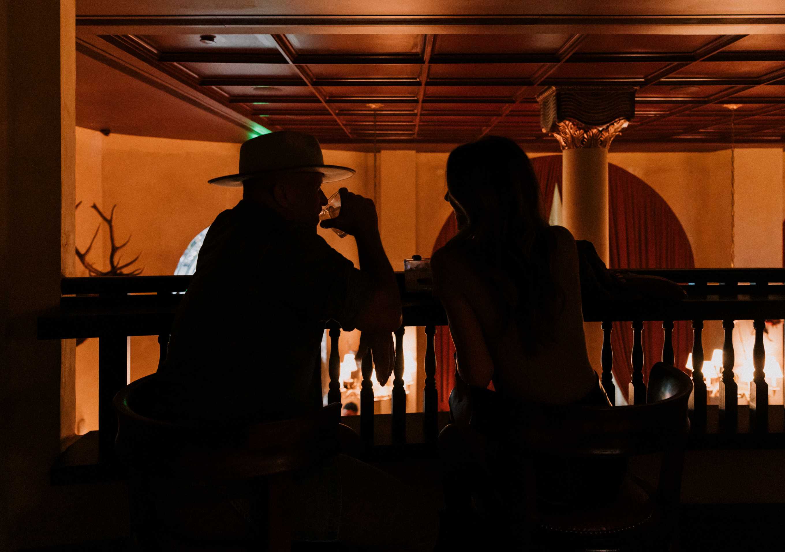 Pool table and a couple sipping drinks at The Victorian Bar 