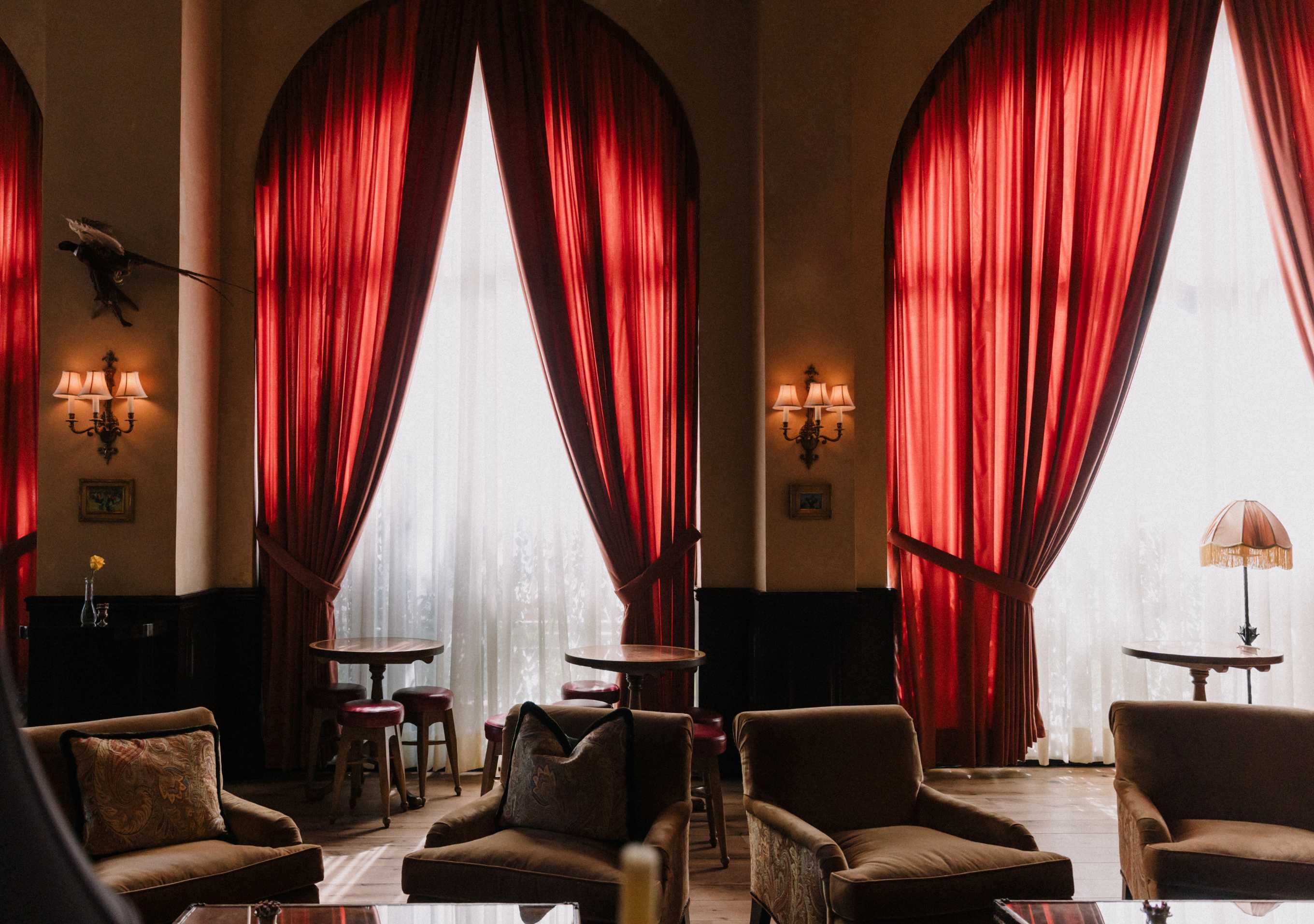 A vintage photograph of Western cowboys having a drink in a saloon-style bar
