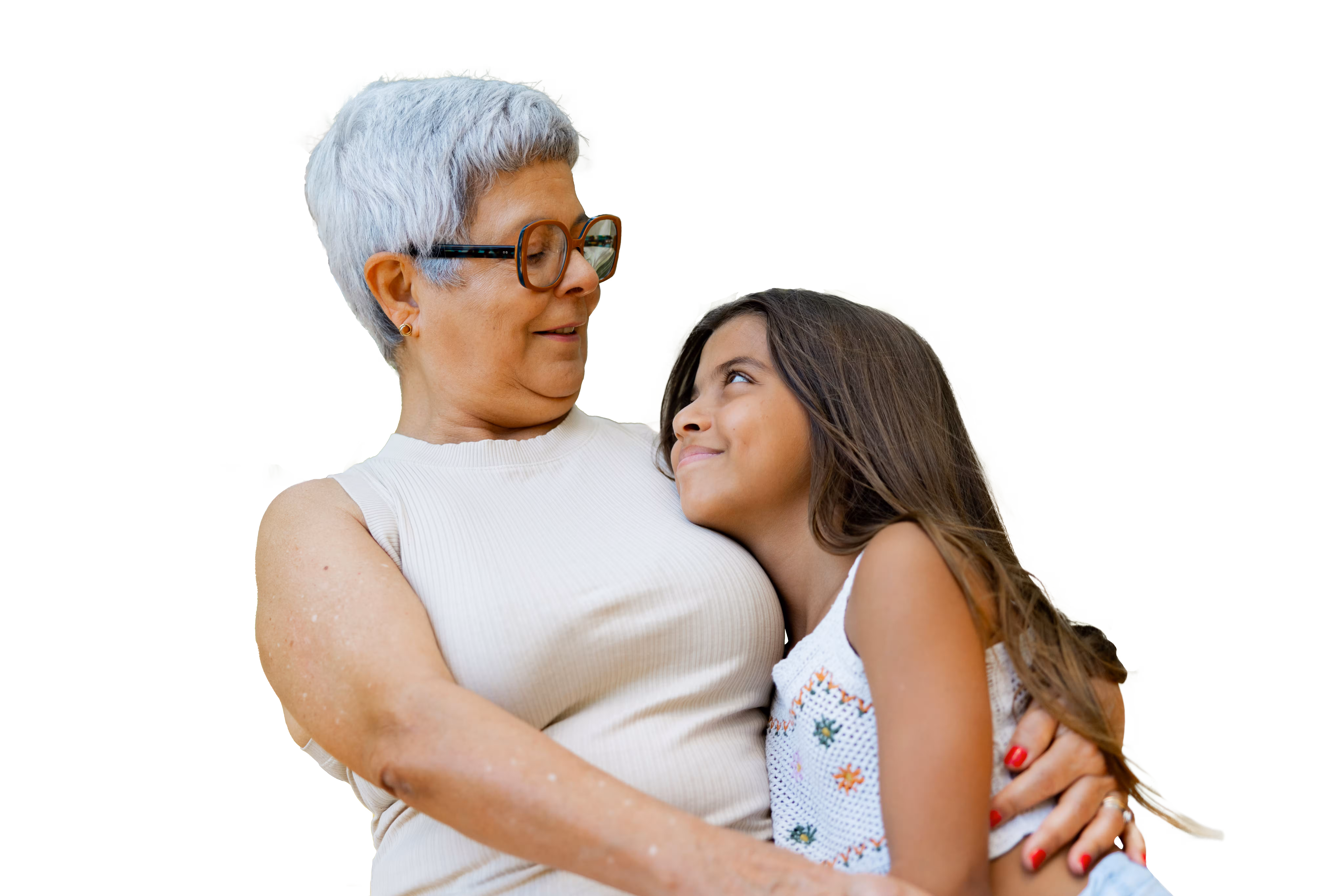 Older woman with gray hair and glasses hugging a smiling young girl with long brown hair.
