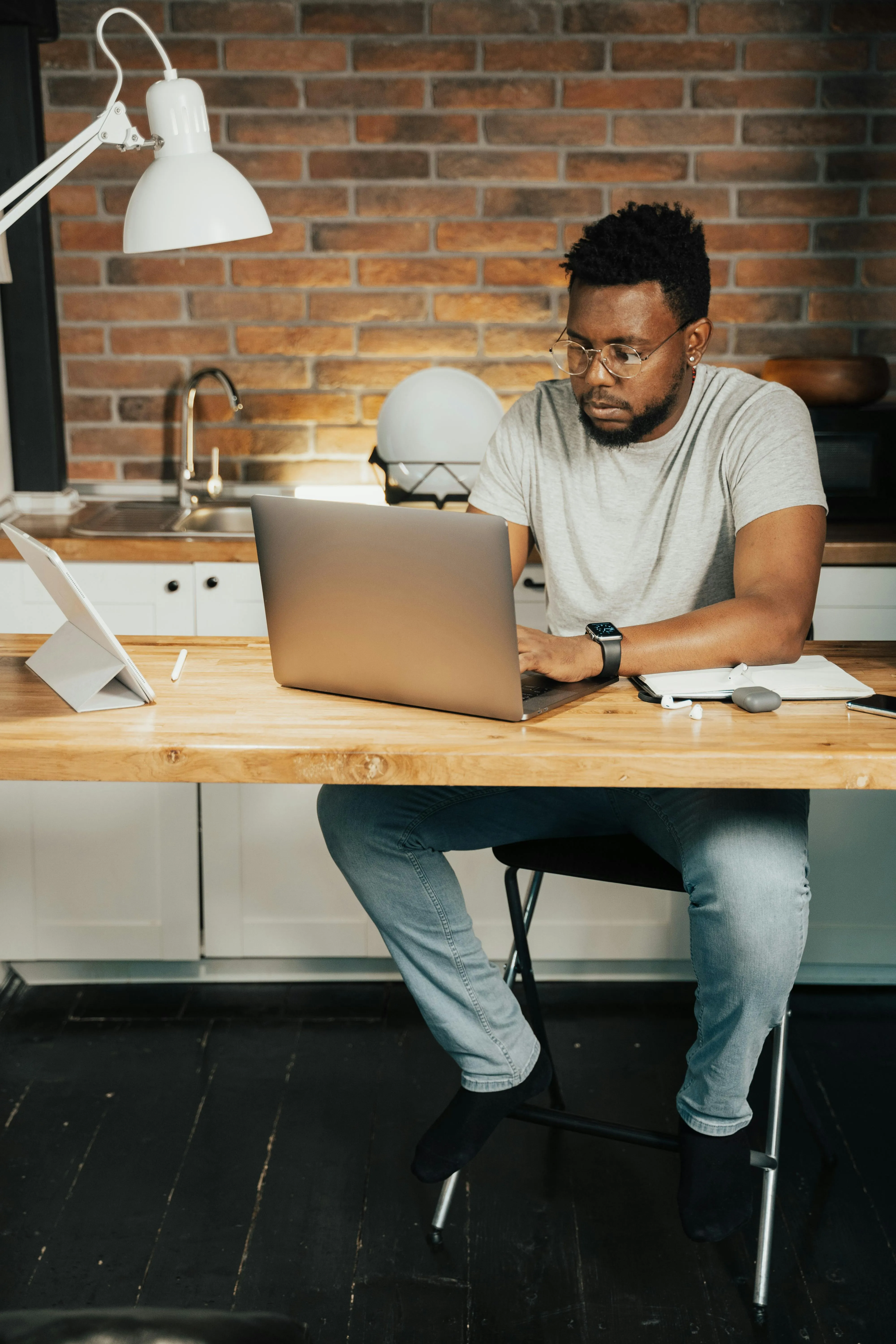 Young professional man reviewing job opportunities and company content on her smartphone, demonstrating proactive interest in a potential employer. 