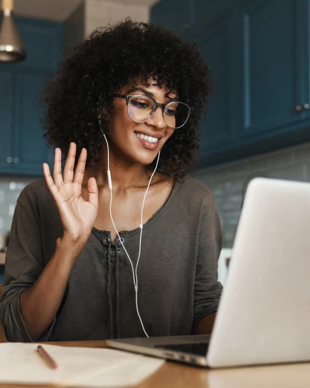 Professional woman completing virtual job interview on laptop hoping for timely hiring feedback.