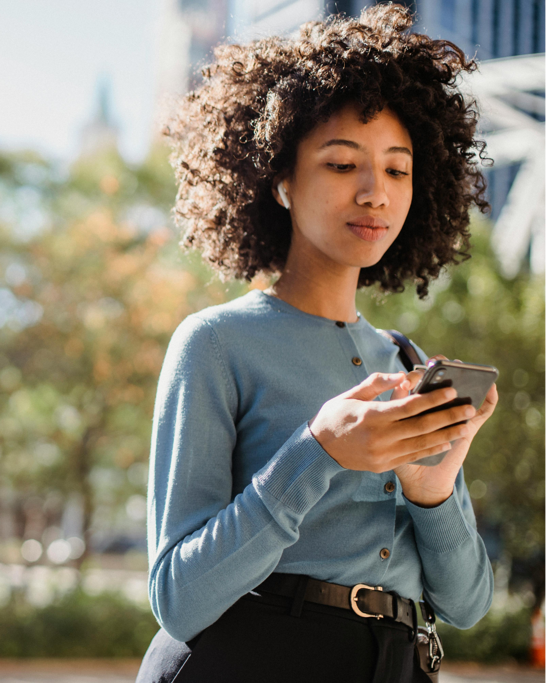 A Gen Z professional checking her phone