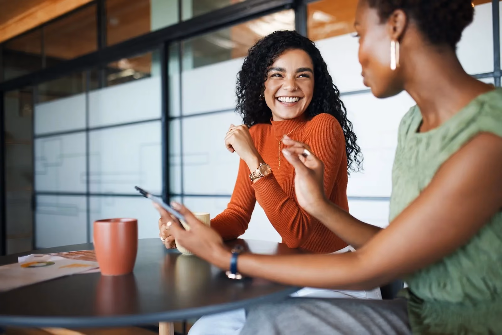 Two young women collaborating at work. 