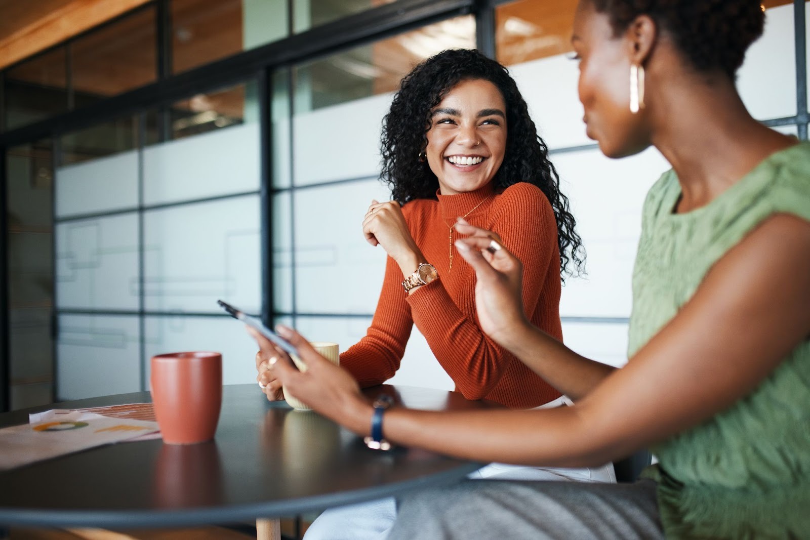 Two young women collaborating at work.