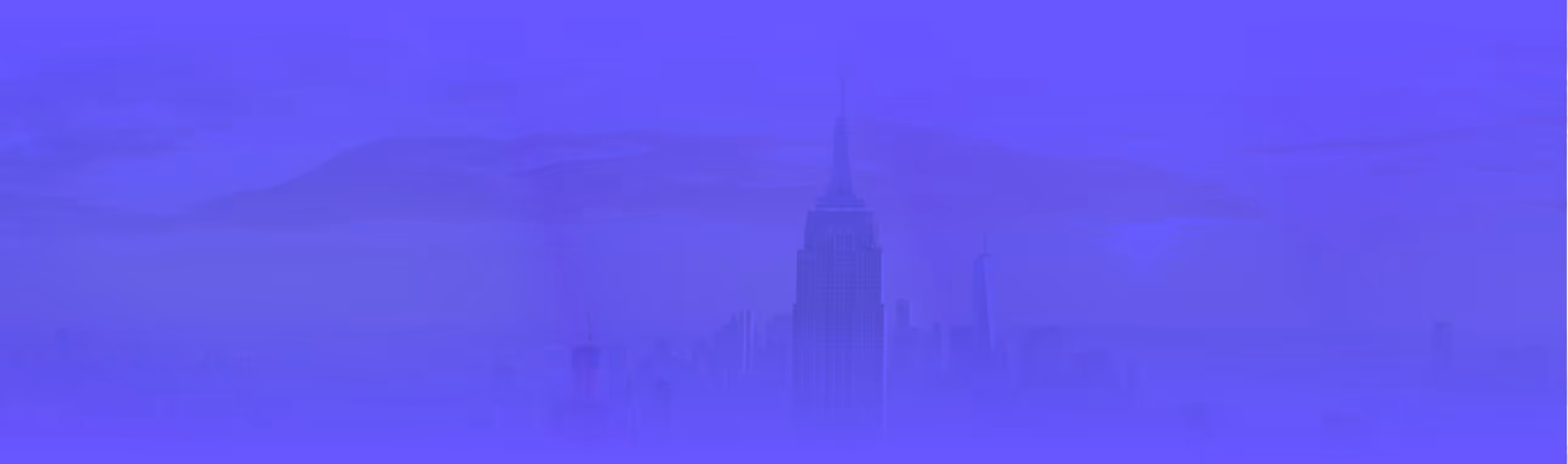 Hazy city skyline with skyscrapers and mountains faintly visible in the background.