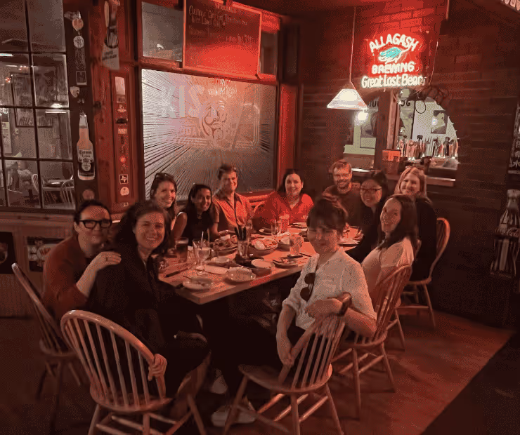Lab members smile together during a meal