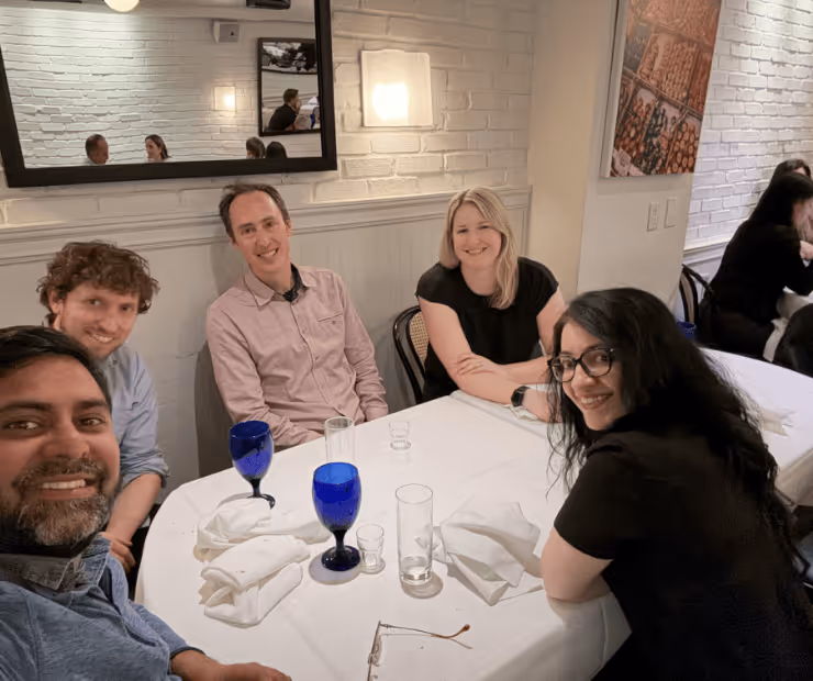 Lab members smile around a table together