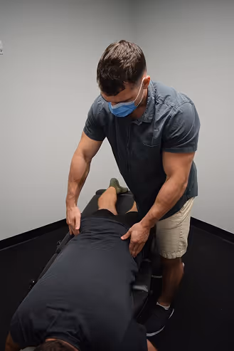Ron Ayello performing chiropractic service
