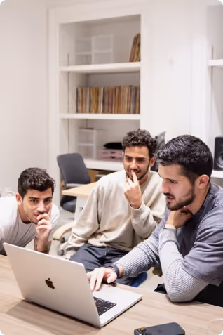 Ben and two men looking at a laptop