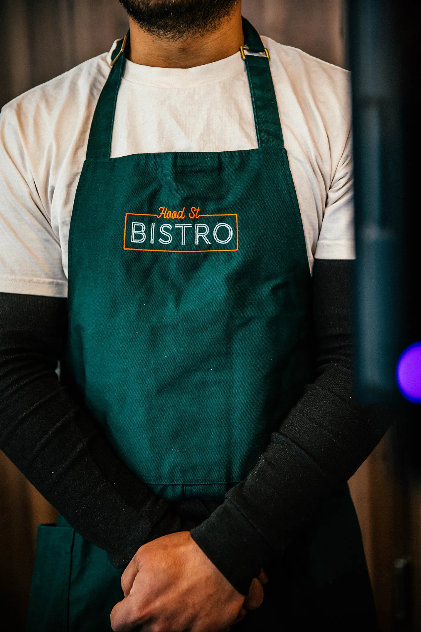 Team member from Hood Street Bistro in Hamilton NZ wearing a branded apron