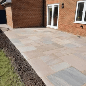 Stone slab patio by red brick house – Lancashire