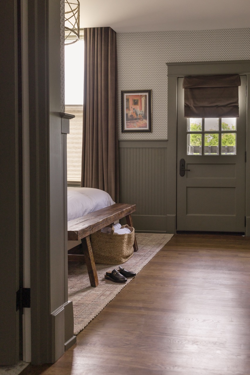 Wood bench at the foot of the bed and the door to the balcony, The Hutton suite