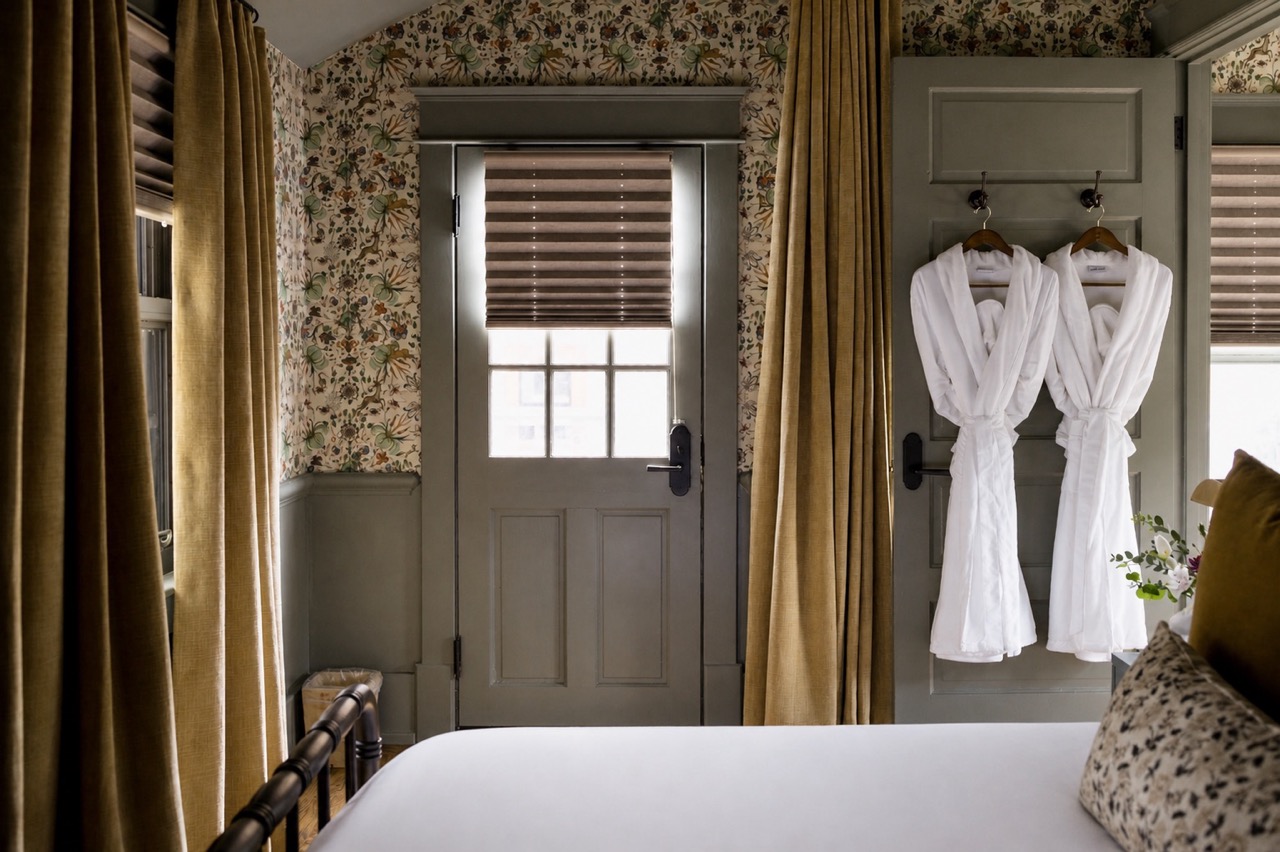 Floral wallpaper, gold velvet drapes and robes by the door, The Bowling suite