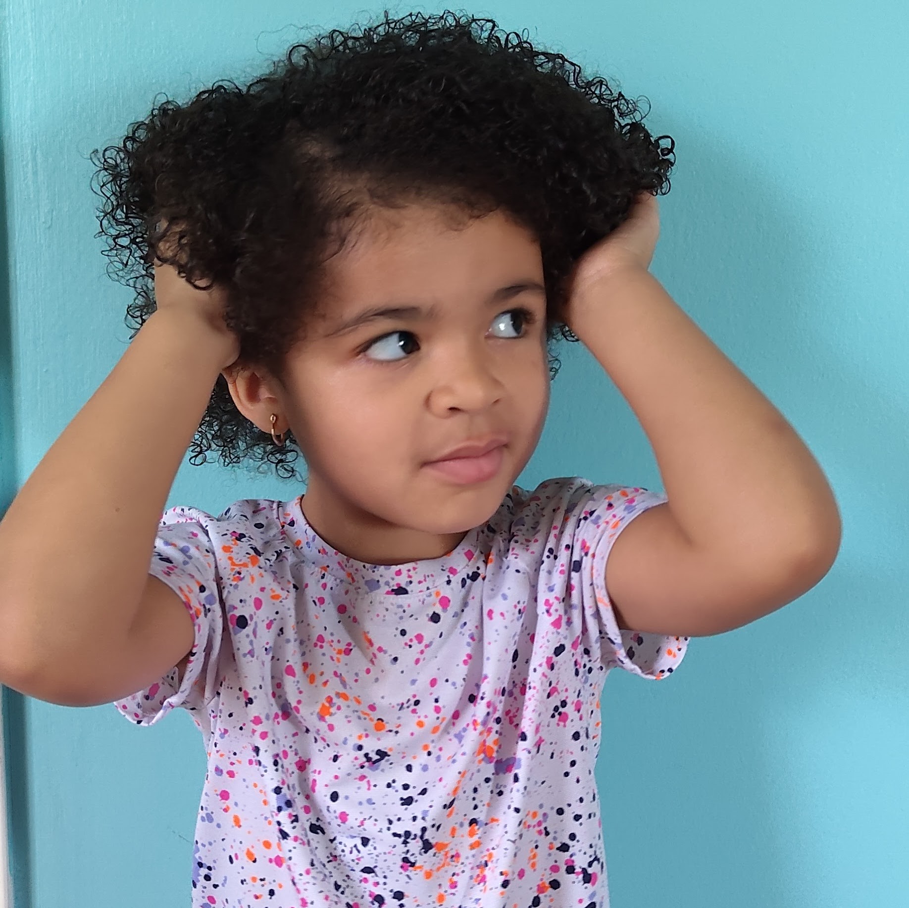 girl touching hair because she likes it