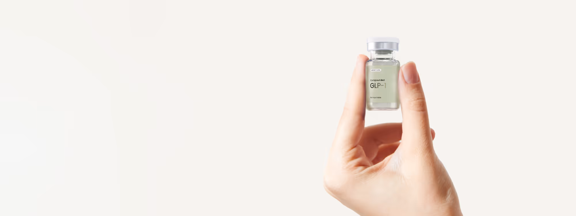 Hand holding a small vial labeled 'effecty GLP-1 injectable' against a plain light background.
