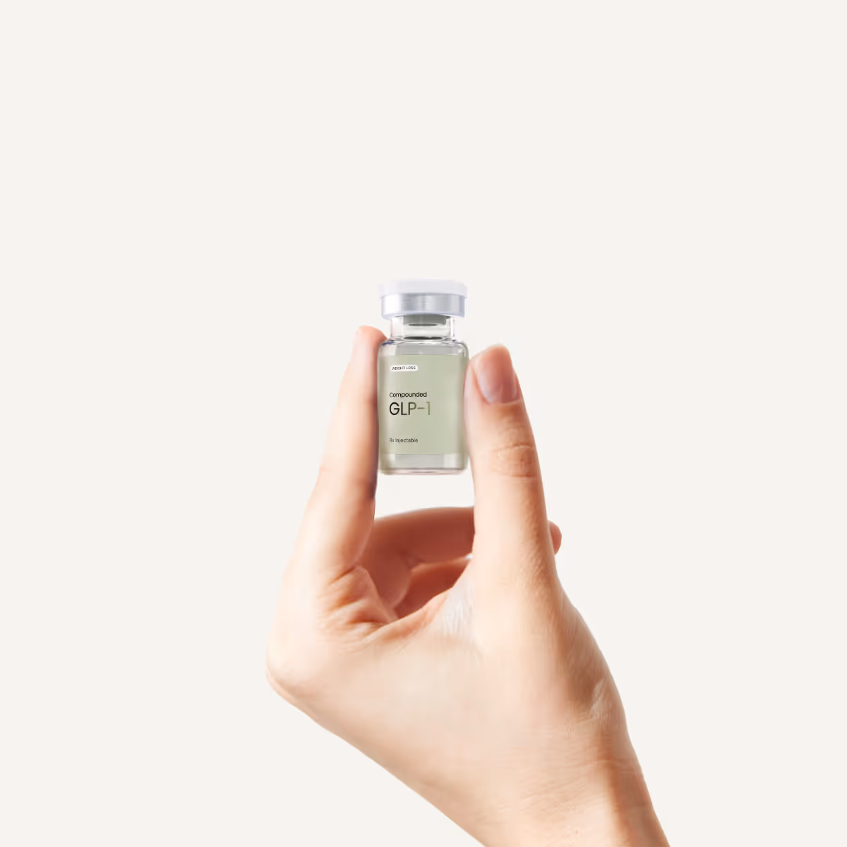 Hand holding a small glass vial labeled 'effecty GLP-1'.