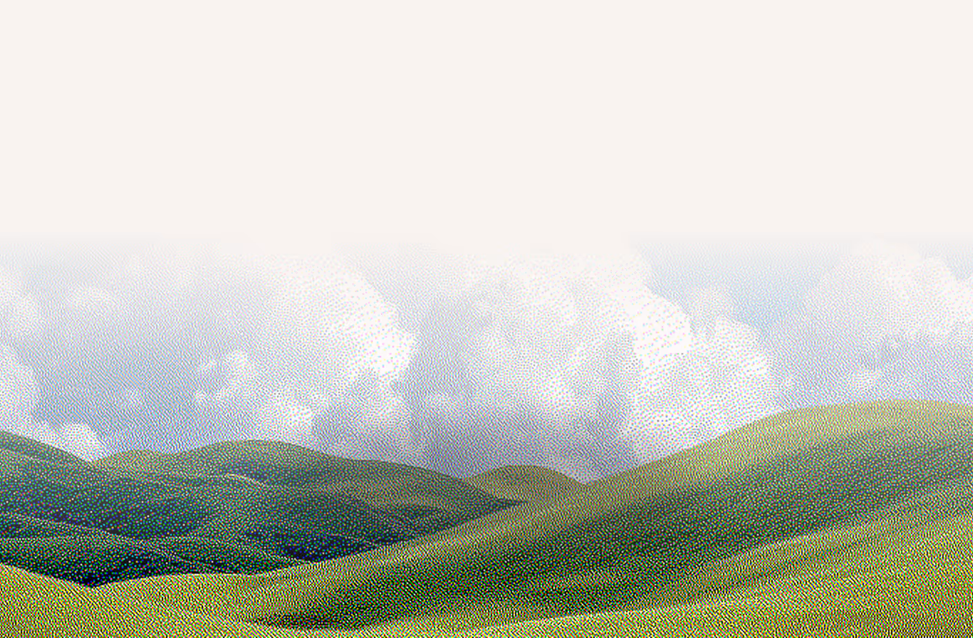 Rolling green hills under a cloudy sky with soft gradients blending into a light background.