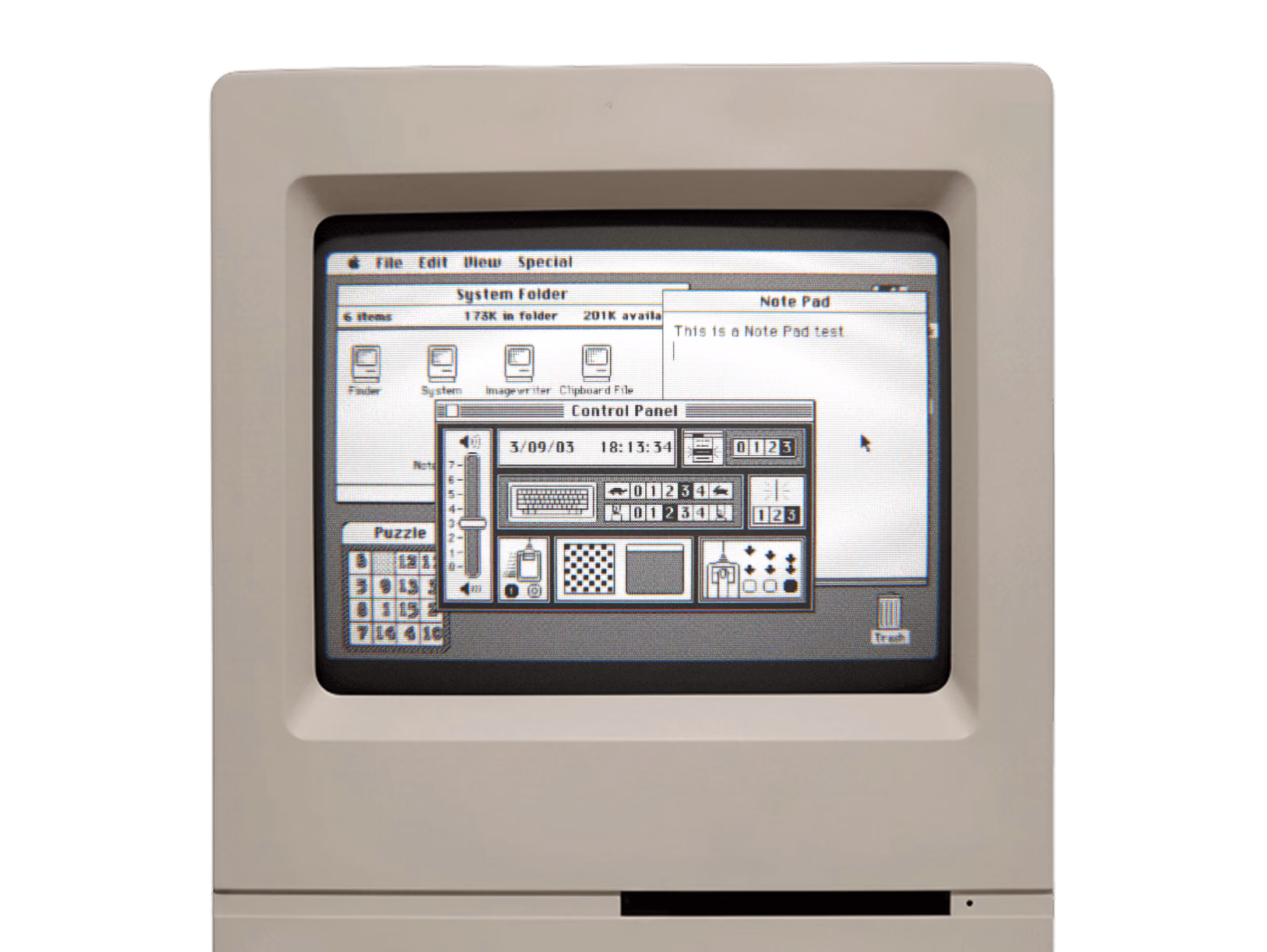 Vintage Macintosh computer displaying a classic black and white desktop interface with open windows including System Folder, Note Pad with text 'This is a Note Pad test,' Control Panel showing date, time, keyboard settings, and other controls, and a Puzzle game window.