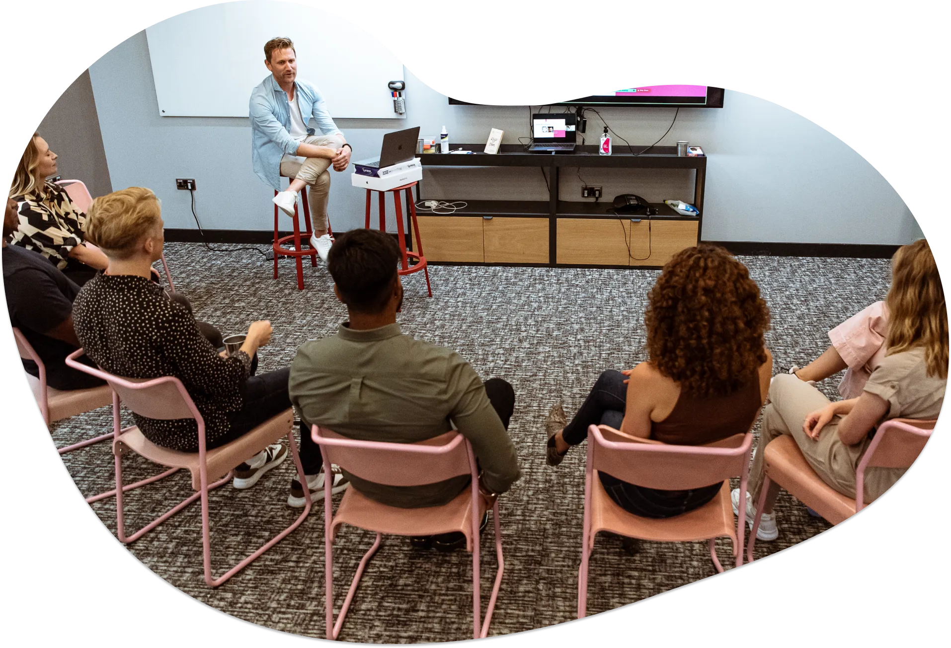 Tom Lavery coaching a group of salespeople sat in a circle in 2021