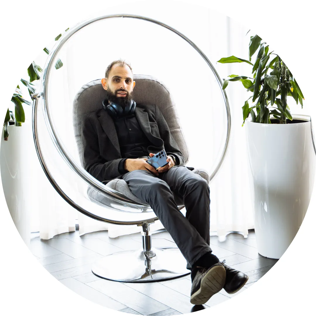 Young SaaS tech employee at Jiminny sat in a modern office