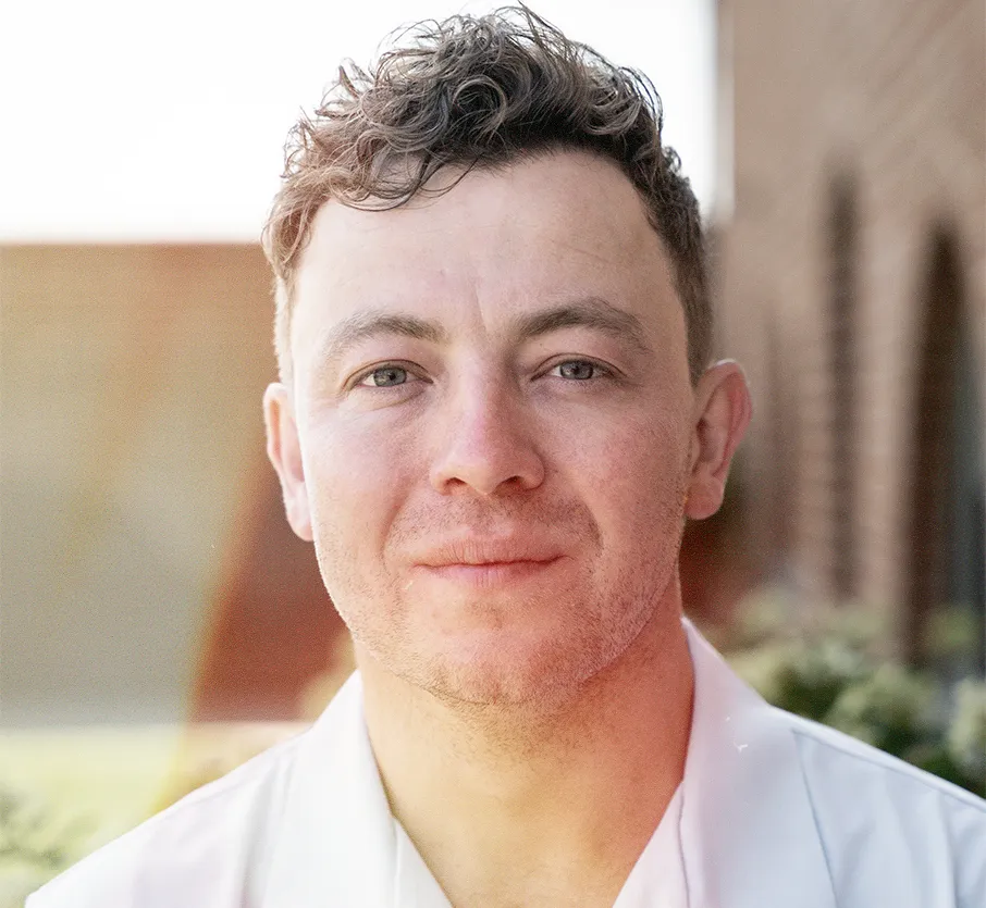 Headshot of Lewis, Founder and Client Director