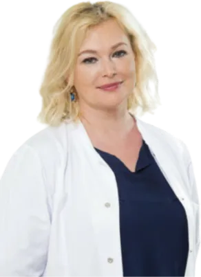 Smiling woman with blonde hair wearing a white lab coat and navy blue top. Specialist in gynecology Rasa Aleksiene