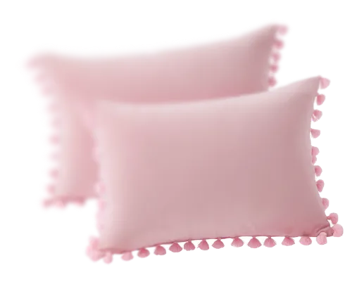 A pair of pink pillows with pom poms.