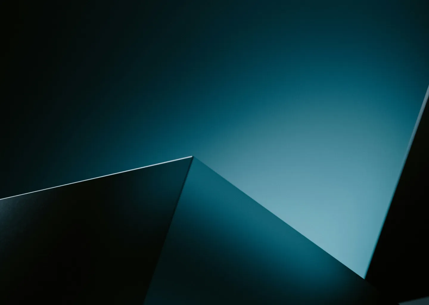 Abstract geometric shapes with sharp edges in dark blue lighting.