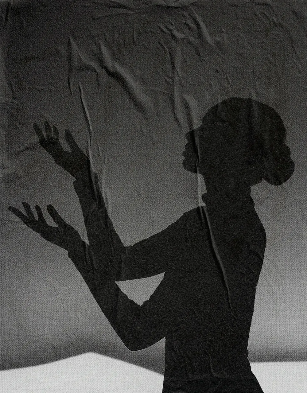 Silhouette of a woman with arms raised against a textured gray background.