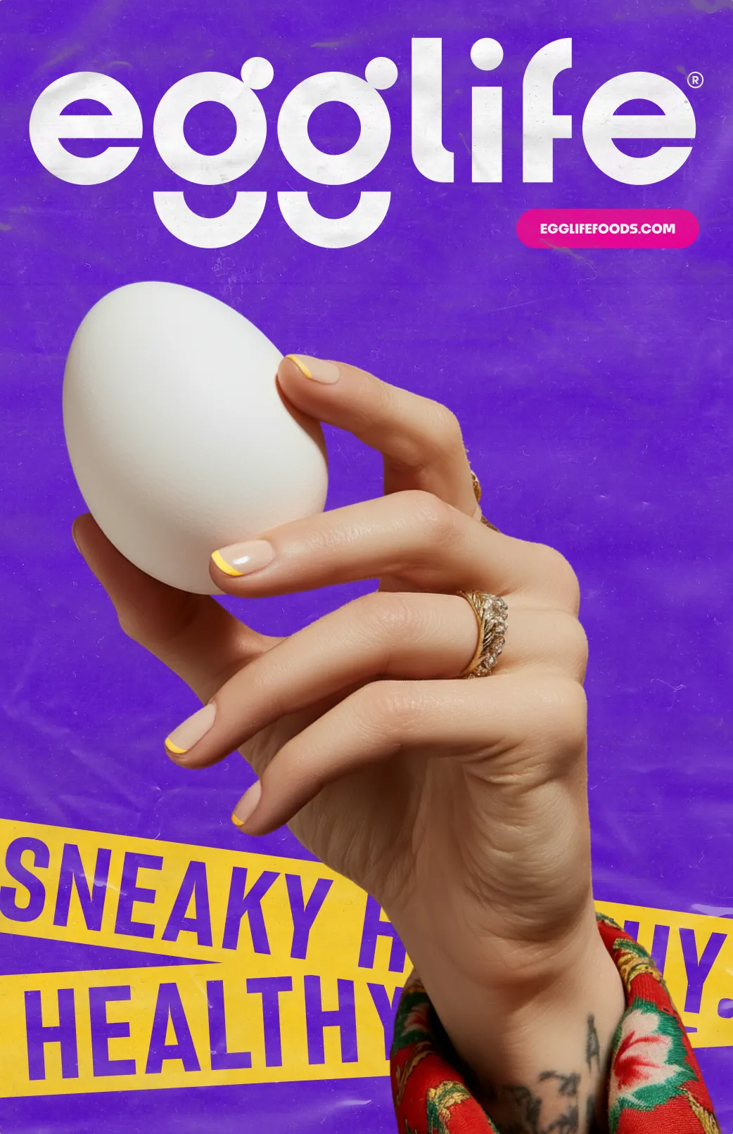 Hand with yellow-tipped nails and rings holding a white egg against a purple background with Egglife logo and partially visible yellow text.