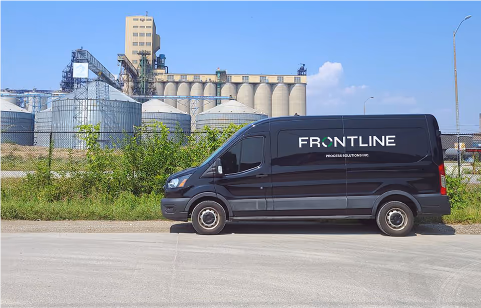 Frontline Freight Work Van in front of rural factory