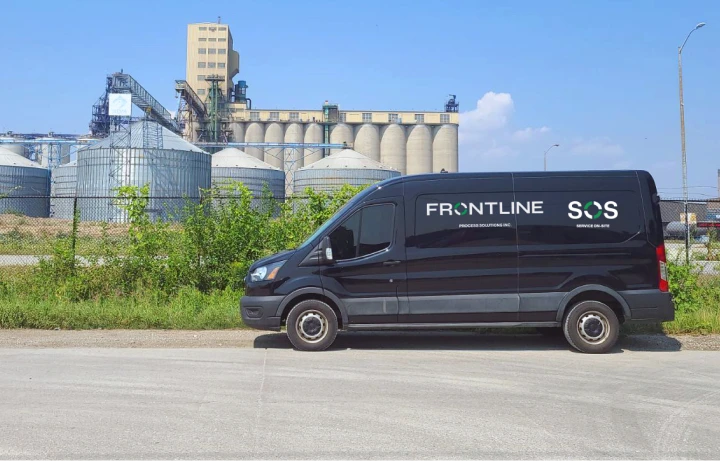 Frontline Freight Work Van in front of rural factory