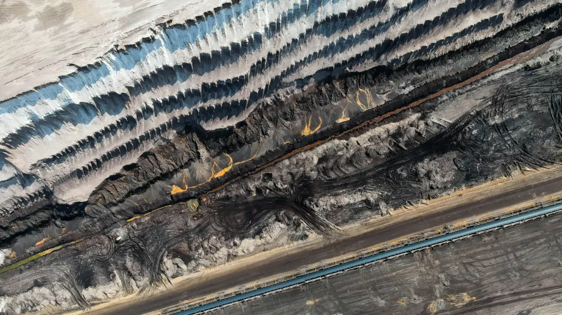 Aerial view of advanced mining machinery operating across layered terrain, showcasing precision engineering and efficient large‑scale resource handling.