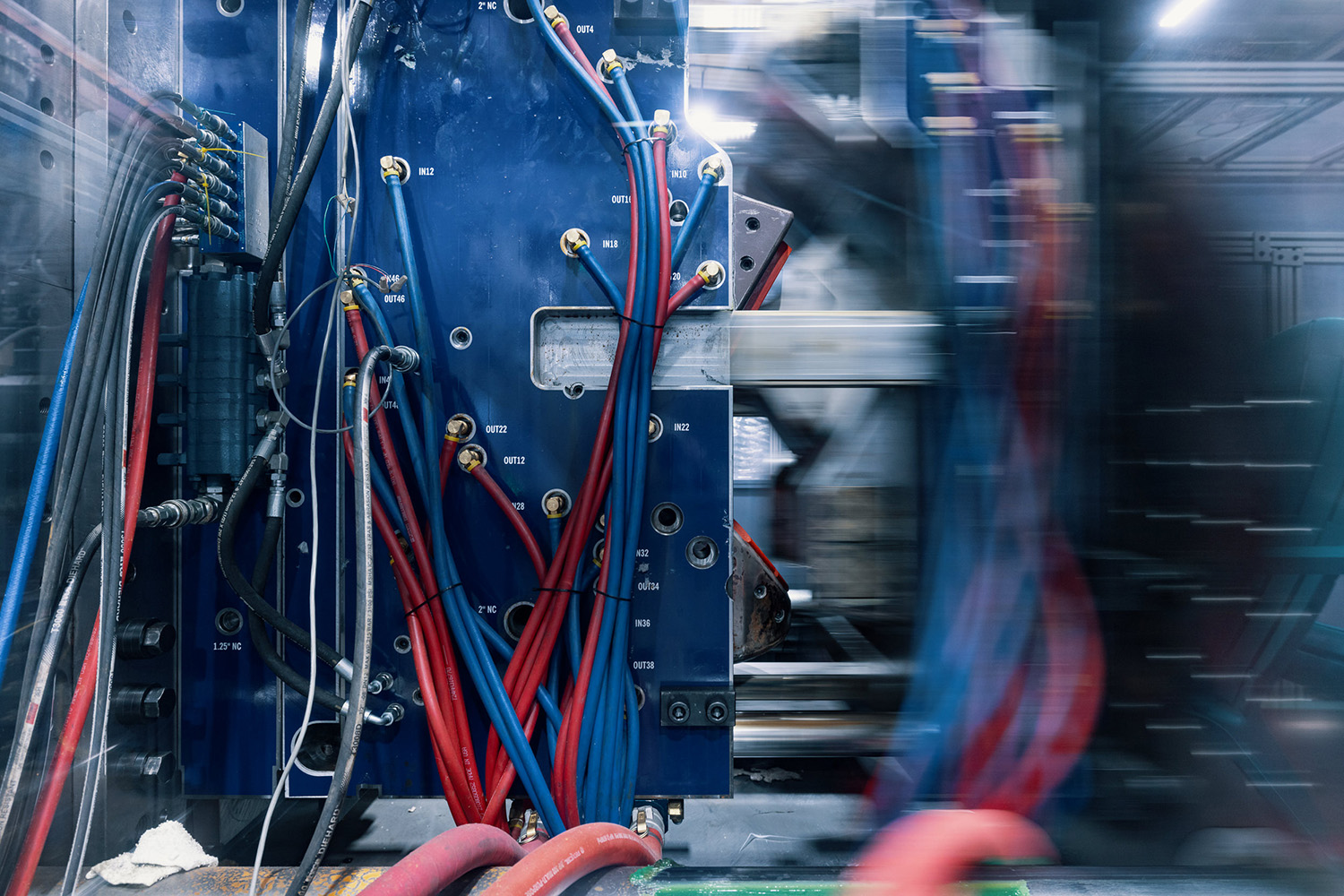 Plastic injection molding machine in motion.