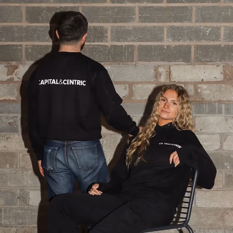 Two people wearing black jumpers