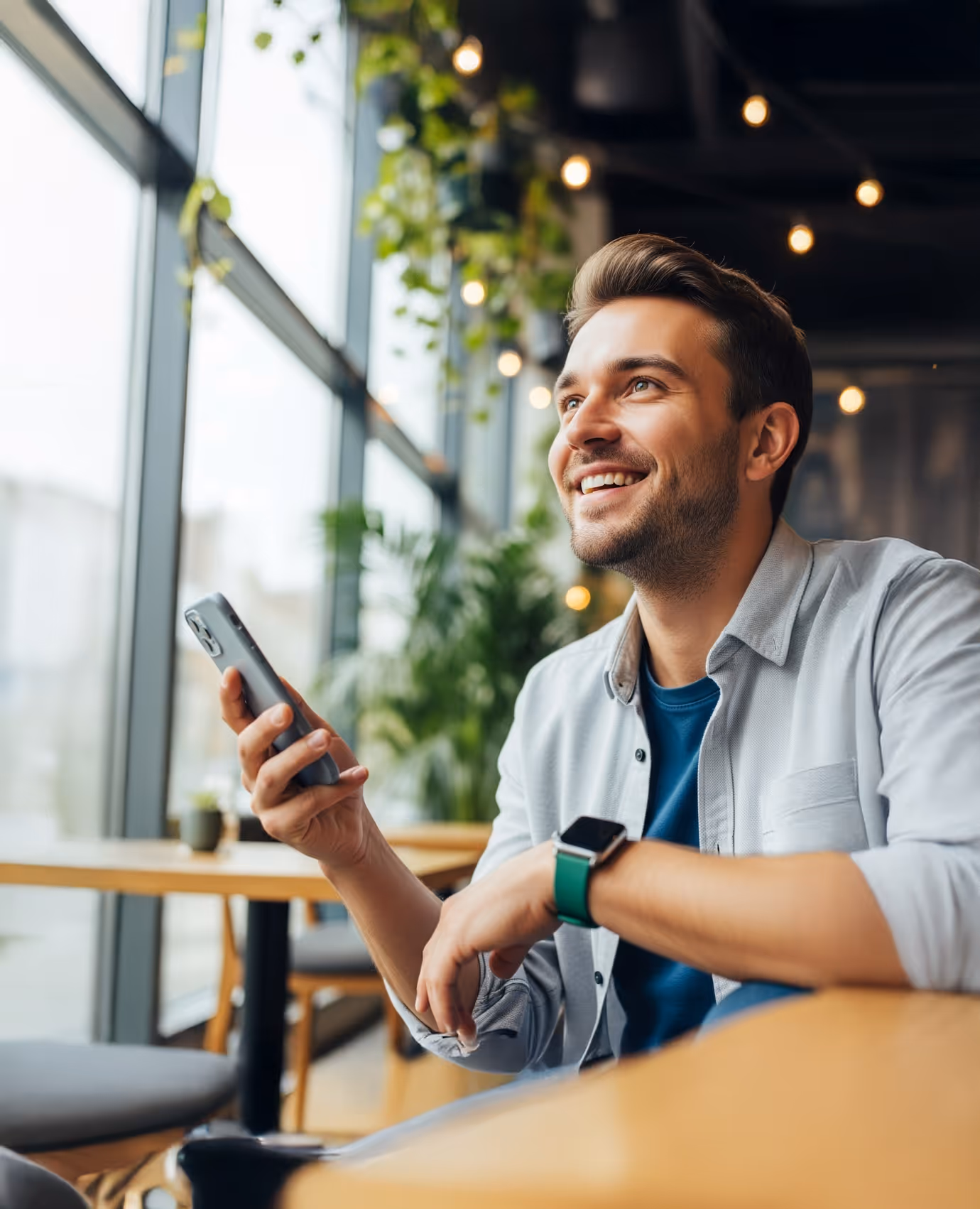 Young professional holding a phone, with Flowcoach app snippet showing personalized coaching and progress tracking.