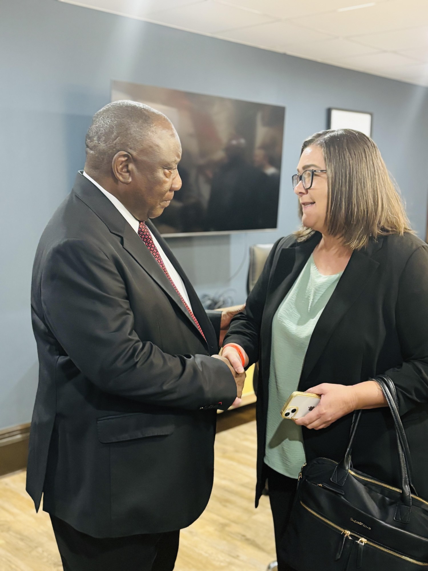 President Cyril Ramaphosa greets a member of the M20 delegation