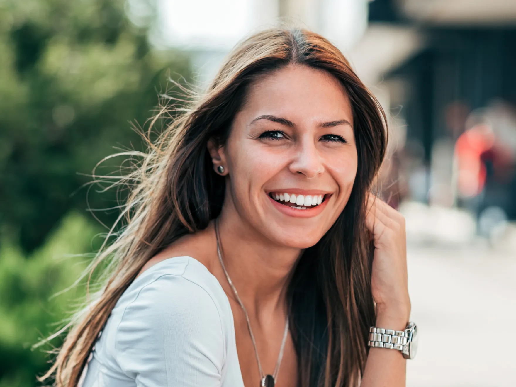 A woman with long hair smiling at the camera.