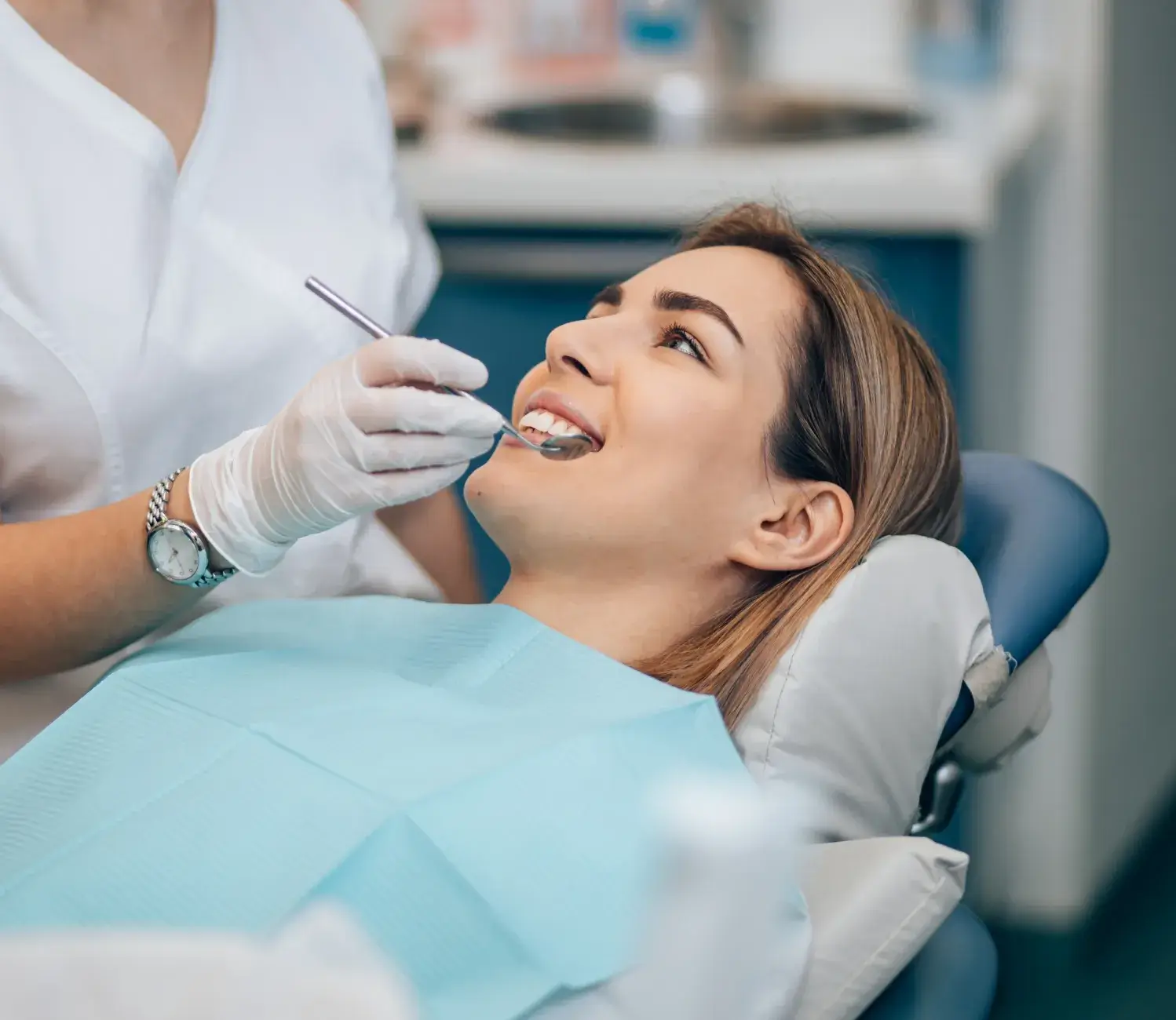 A woman getting her teeth checked by a dentist.