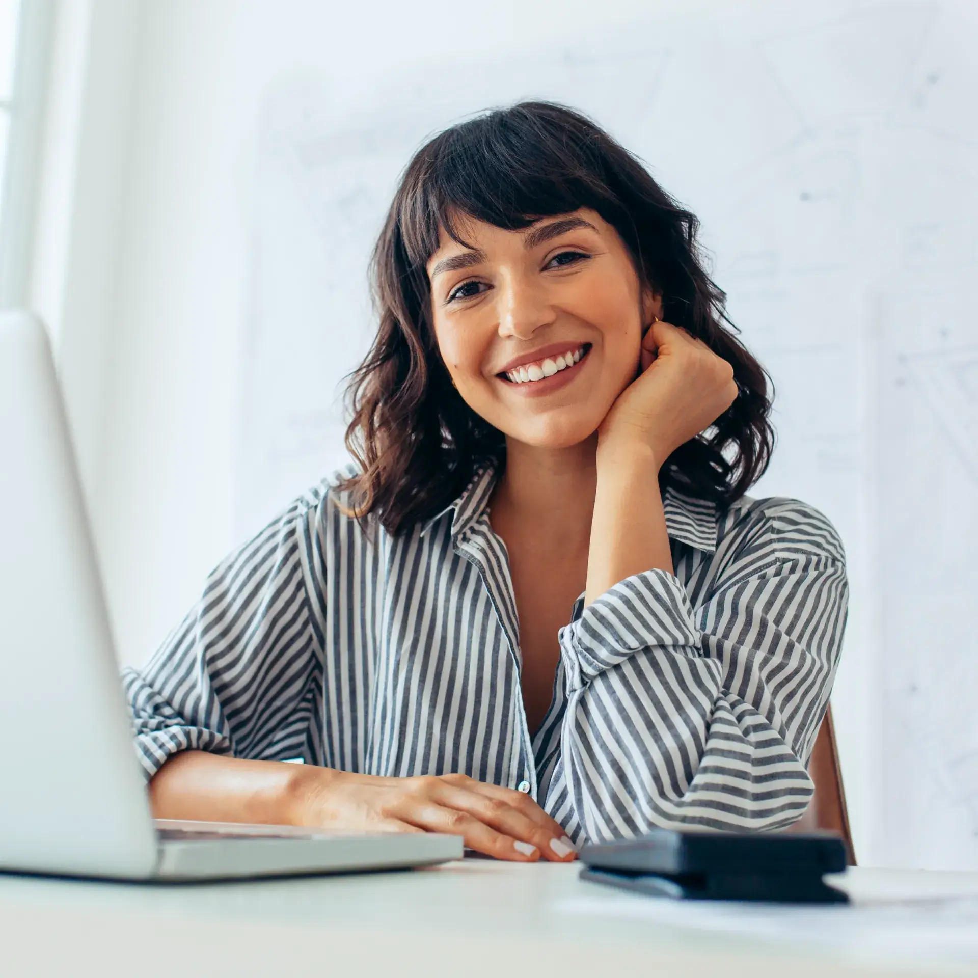 A woman sitting in front of a laptop computer.