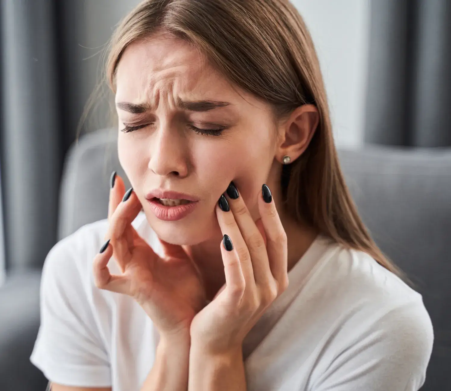 A woman holding her hands to her face.