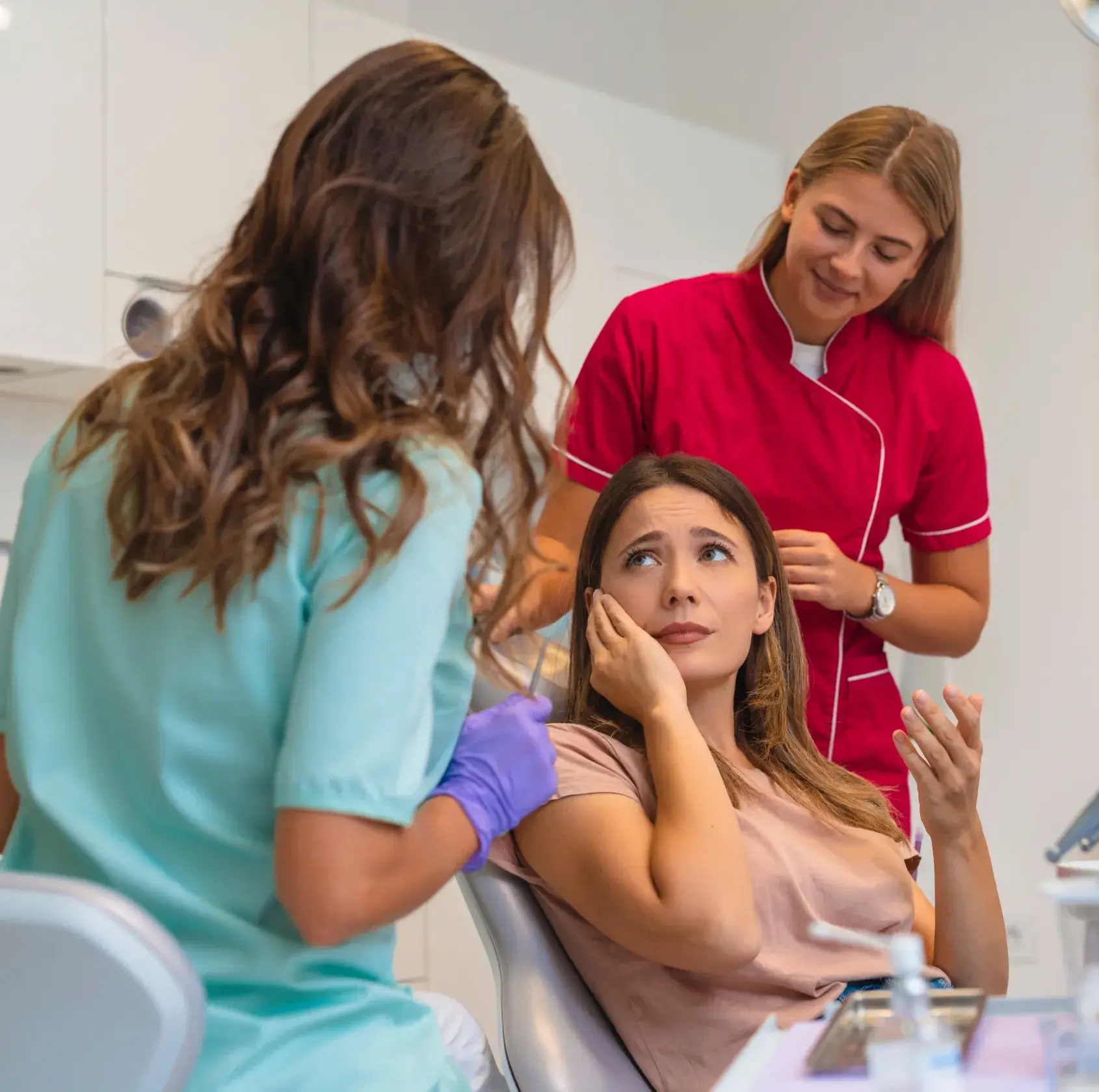 A woman getting her hair done by a hair stylist.