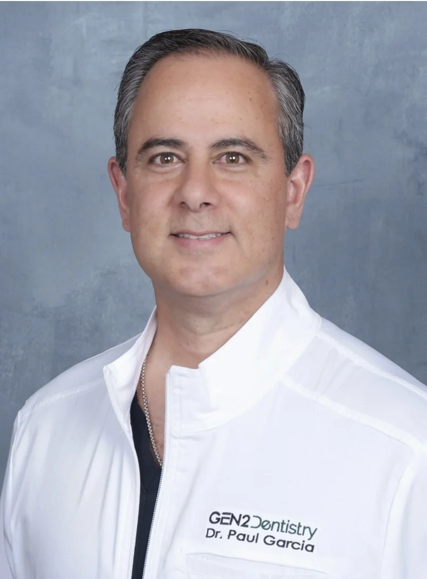 A man wearing a white shirt and black tie.